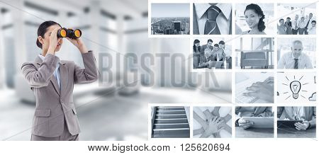 Portrait of a brunette businesswoman looking through binoculars against modern room overlooking city