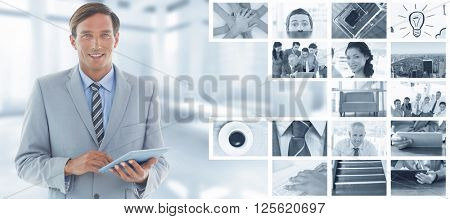 happy businessman using tablet pc against modern room overlooking city