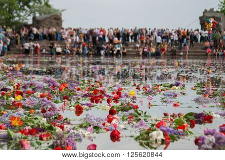 VOLGOGRAD RUSSIA - MAY 9 2010: Flowers floating in the the Lake of Tears on Mamaev hill in Volgograd