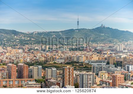 Barcelona Spain - May 18 2014: The view of Barcelona from high up in the Renaissance Barcelona Fira Hotel. Visible on the horizon television tower Collserola and Temple of the Sacred Heart of Jesus.