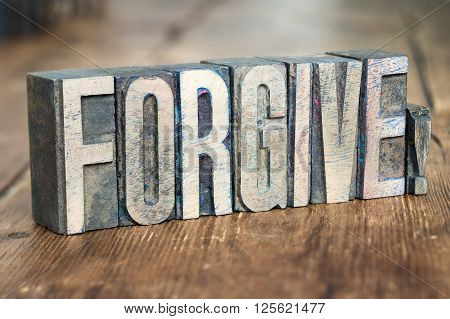 forgive exclamation made from wooden letterpress type on grunge wood