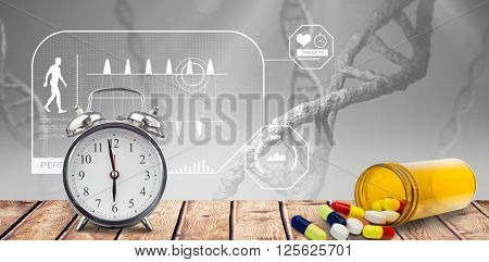 Alarm clock and pills put on a desk against view of dna