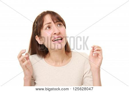 studio shot of perplexed woman on white background