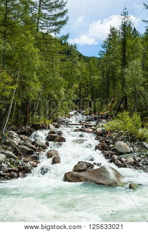 Stream falls in river Akkem. River flowing from glacier and Beluha range. Russia