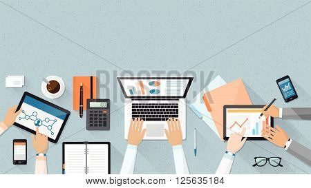 Business team working together at office desk they are using laptops and checking financial reports corporate management and accounting concept