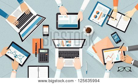 Business team working together at office desk they are using laptops and checking financial reports corporate management and accounting concept