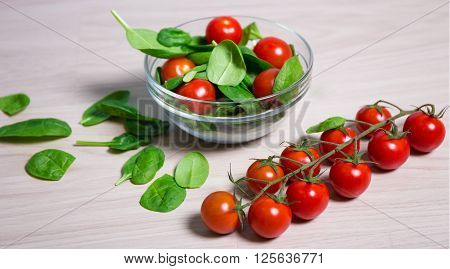 Healthy Food Concept - Spinach And Tomatoes On Wooden Table