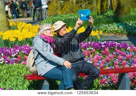 LISSE THE NETHERLANDS APRIL 11 2016: Tourists are visiting 'the Keukenhof'in the spring. The Keukenhof is a popular flower garden which is visited by a million tourists from all around the world. It is open for only six weeks every year.