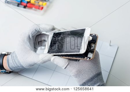 Close-up photos showing process of mobile phone repair, changing the screen.