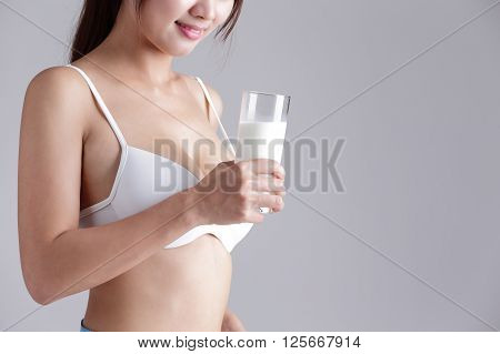 Milk and Health woman body - Woman smile with milk for Healthy lifestyles concept with gray background asian beauty