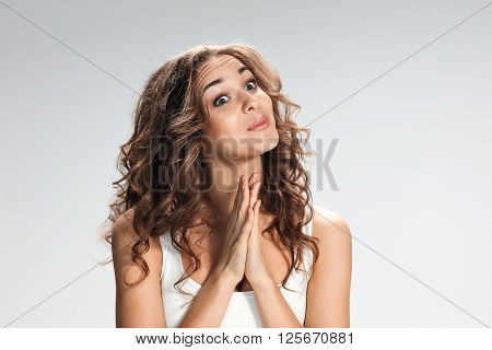 The Woman is looking imploring  over gray background