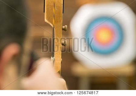 Archer aiming against the blurred target. Close up view
** Note: Shallow depth of field