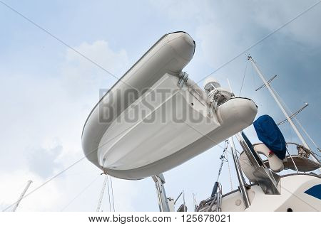 Dingy boat Inflatable setup behind of the yacht for transportation