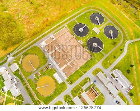Aerial view to biogas plant from sewage treatment in green fields. Renewable energy from biomass. Waste management for 165, 000 inhabitants of Pilsen city in Czech Republic, Europe. 