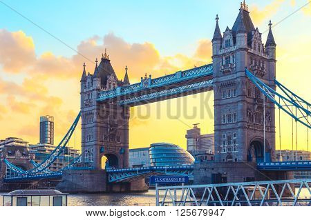 London, UK - March 31, 2016 - Tower Bridge and St. Katharine Pier against orange sunset sky