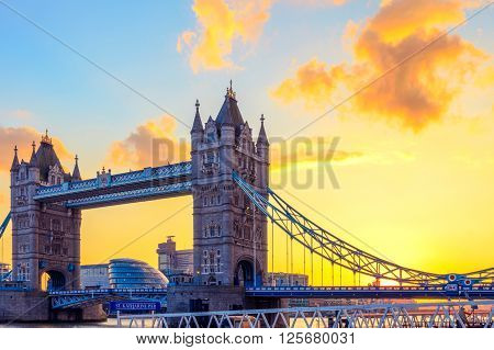 London, UK - March 31, 2016 - Tower Bridge and St. Katharine Pier against orange sunset sky