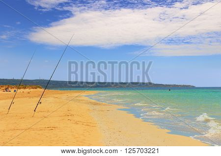 The most beautiful sandy beaches of Apulia. ITALY(SALENTO).From Torre Pali to Pescoluse the shore is made of a so fine white sand and vashed by a so clear sea that it is called 'Maldive of Salento'.Location of a fisherman: fishing poles stuck in the sandr