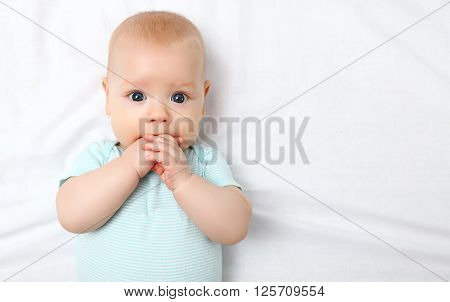 a happy newborn baby on the bed at home