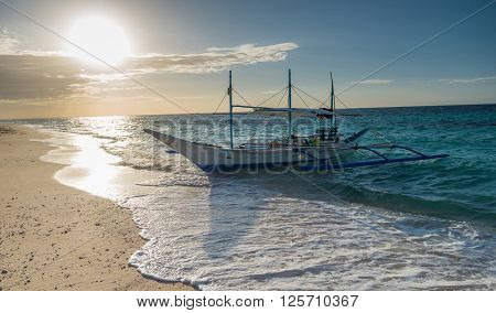 Tropical background sunset view from Boracay island at Puka beach with traditional Philippines boat, blue sky and turquoise sea water, Travel Vacation at Philippines,