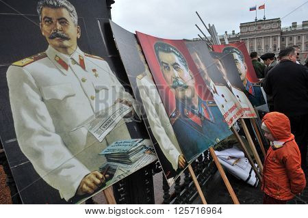 ST. PETERSBURG RUSSIA - MAY 1: Portraits of Russian dictator Joseph Stalin at the fence of the monument to the Russian Tsar Nicholas 1 during a May Day demonstration in May 1 2010