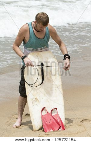 Causasian man just finished surfing on the waves Sea beach san