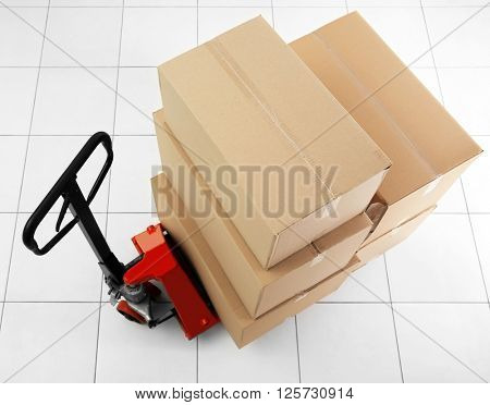 Manual pallet truck with carton boxes indoors