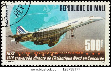 MOSCOW RUSSIA - APRIL 12 2016: A stamp printed in Mali shows supersonic passenger aircraft Concorde devoted to the 15th Anniversary of First North Atlantic Crossing by Concorde circa 1988