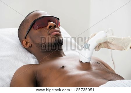 Therapist Giving Laser Epilation On Man's Chest