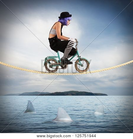 Clown on a bicycle on a rope