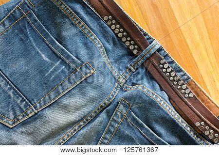 blue jeans with brown leather belt, clothing industry