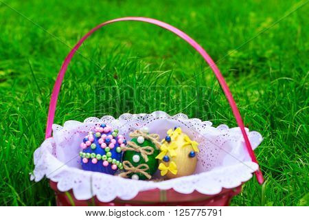 Easter eggs in a basket on green grass