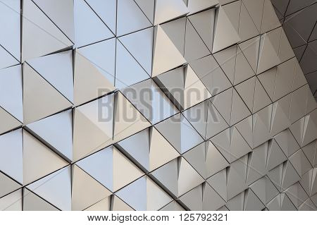 Abstract close-up view of modern aluminum ventilated facade of triangles