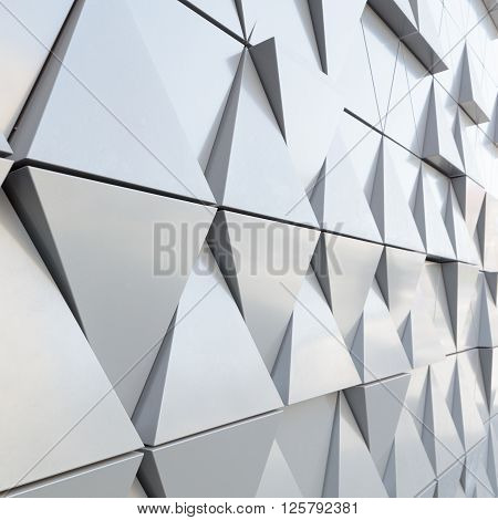 Abstract close-up view of modern aluminum ventilated facade of triangles