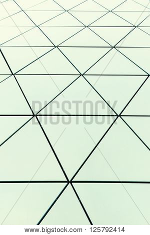 Abstract close-up view of modern aluminum ventilated facade of triangles