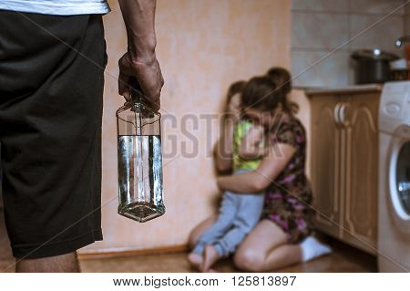 Woman covering her child from angry drunk father. Domestic violence.
** Note: Shallow depth of field
