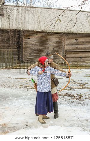 Vitoslavlitsy, Russia - March 12, She takes aim from a bow, March 12, 2016.
Holiday Carnival in general Vitoslavlitsy near Novgorod.