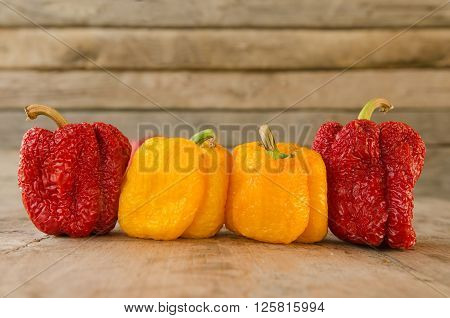 Wilted sweet peppers on a wooden table