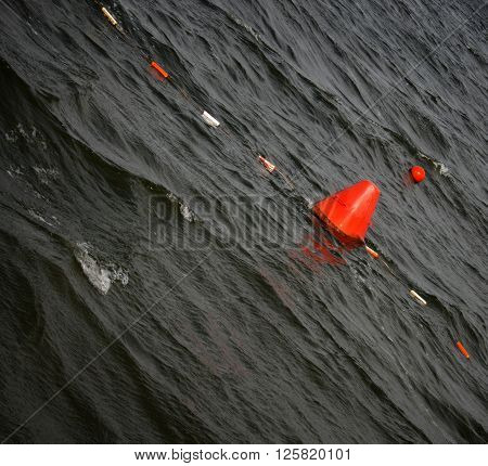 Floating red navigational buoy on lake in Ukraine