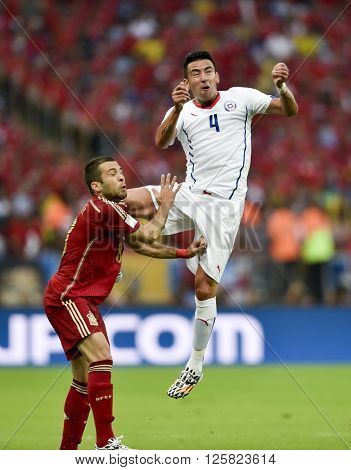 RIO DE JANEIRO BRAZIL - June 18 2014: Arturo VIDAL of Chile and Xavi HERNANDEZ of Spain during the FIFA 2014 World Cup. Spain is facing Chile in the Group B at Maracana Stadium
