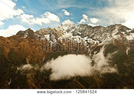 Thamserku mountain in deep valley in Himalaya mountains on the way to the Everest base camp