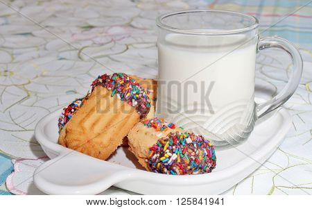Cookies with sprinkles and a glass of milk