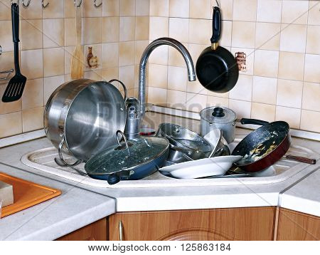 Many of dirty dishes in the sink in the kitchen
** Note: Visible grain at 100%, best at smaller sizes