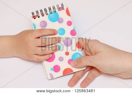 mother's arms transfer multicolored polka dots sealed spring notebook in hand Children