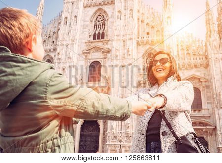 Mother wit son take for hands on the squere near Duomo di Milano