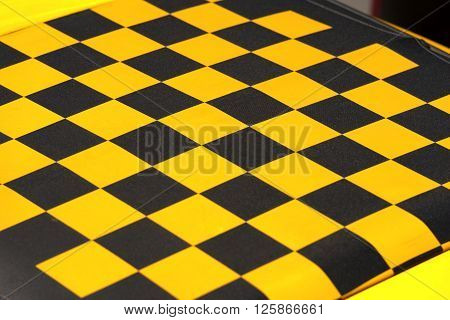 Detail of the roof of a car yellow and black checkered. Fabric sunroof