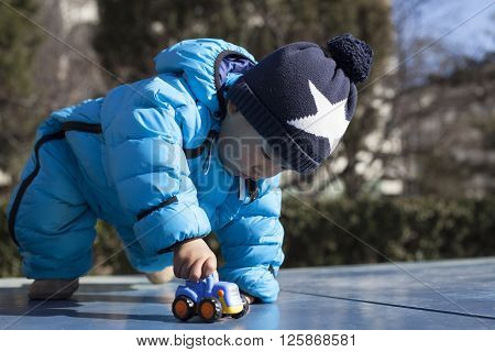 Cute Chinese baby boy playing on a table tennis table shot in Beijing China