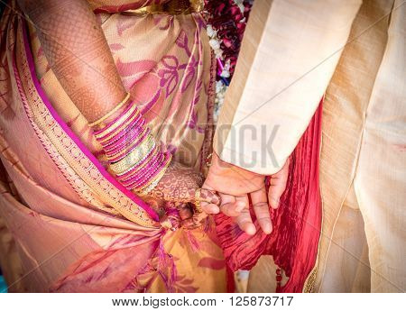 Bride and Groom Hands Together at an Indian Wedding Ceremony