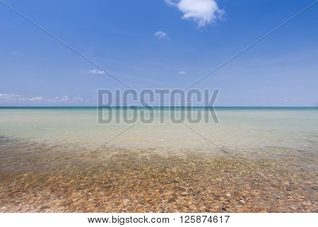 Gravel on the beach with blue sky