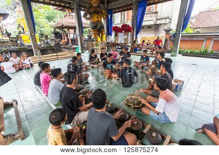 UBUD, INDONESIA - MAR 1, 2016: Unidentified teenagers at the time of preparations for Ngrupuk parade, which takes place on the eve of Nyepi day in Bali. Nyepi is a public holiday in Indonesia.