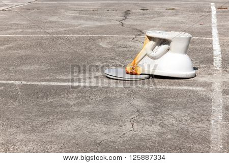 flush toilet upside down on outdoor cement. concept do not let anyone take only a stool sputum urine spit filth into the pond or in the public